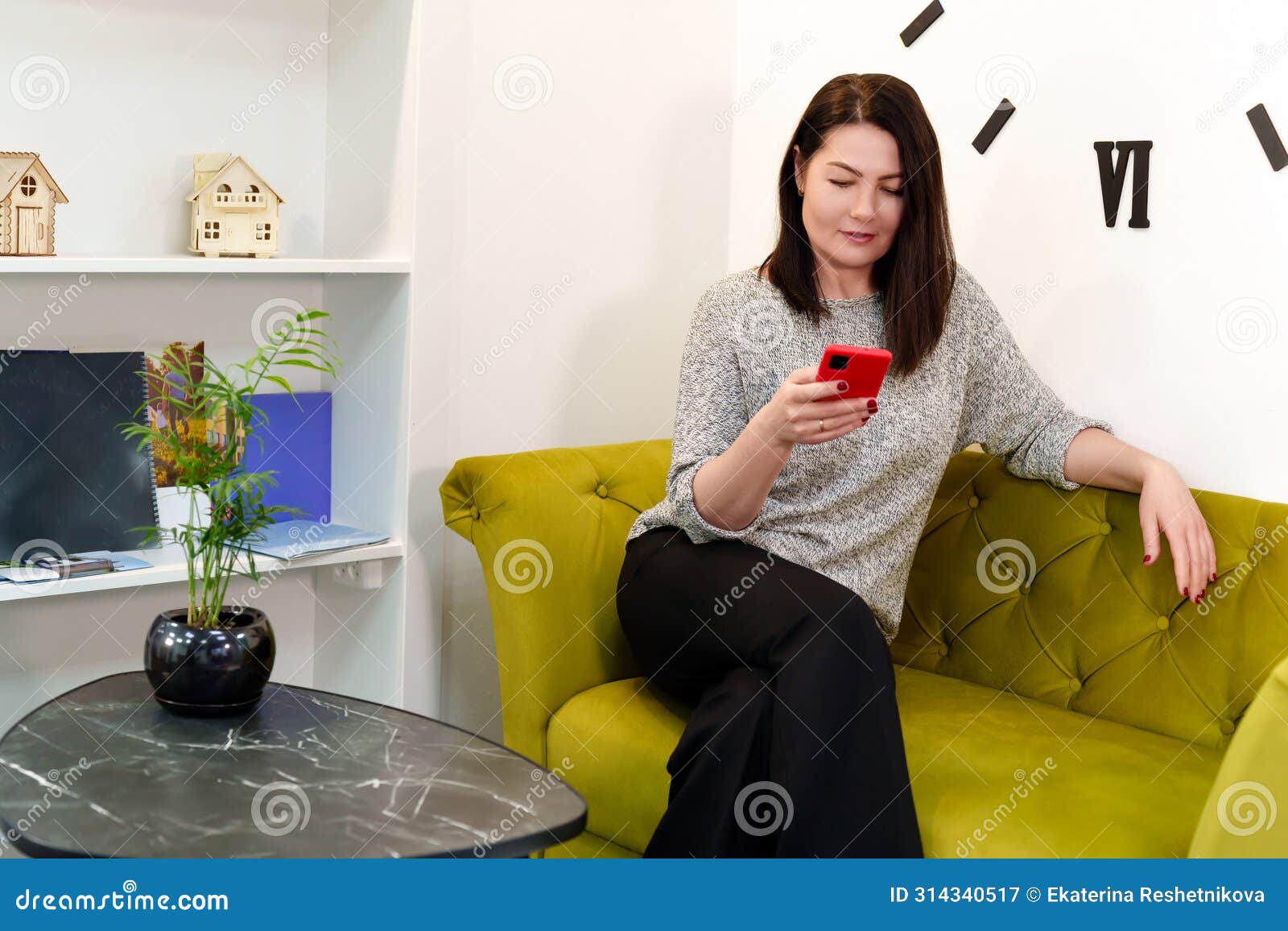 Communicative And Responsible Girl Conducts Business Correspondence Over The Phone At Ease On A