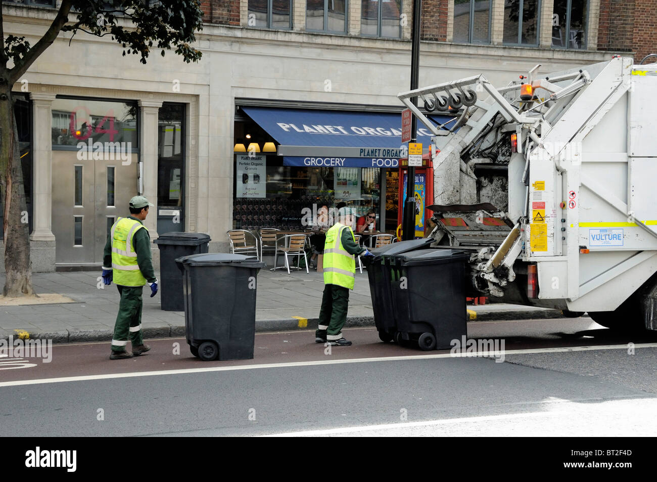 Rubbish Collection Bin Men Working At The Back Of A Lorry London