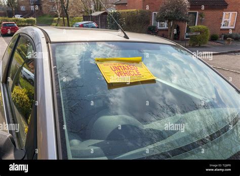 Untaxed Vehicle Sticker On The Windscreen Of A Car Immobilised At The